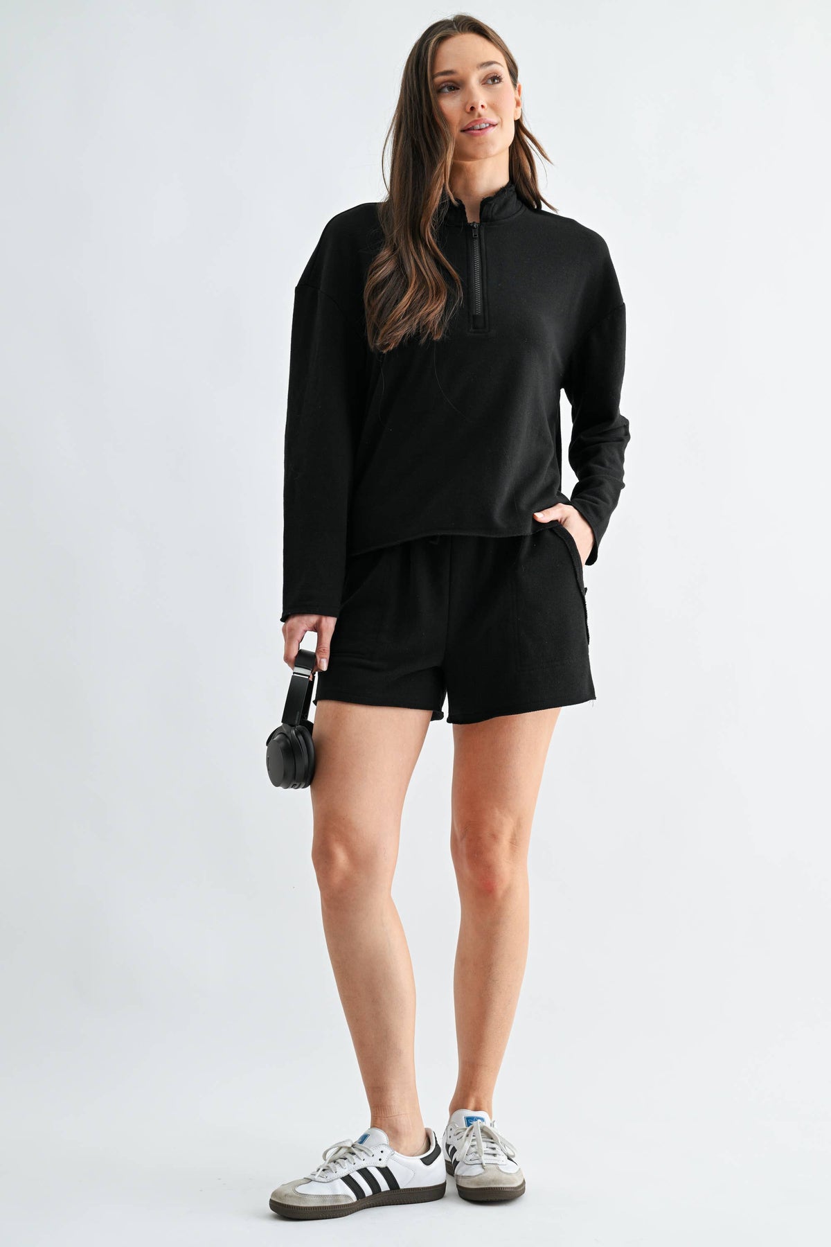 Woman wearing a black outfit with a white background