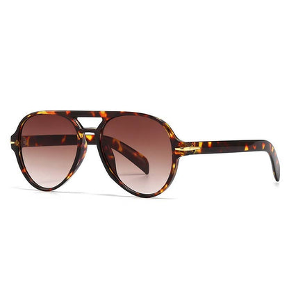Tortoiseshell sunglasses with brown gradient lenses on a white background