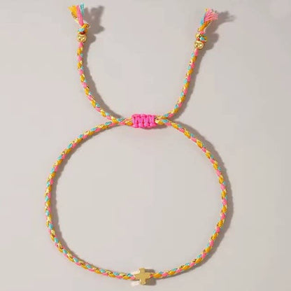 Colorful braided bracelet with a small charm on a light gray background