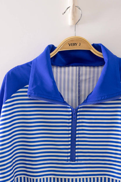 Blue and white striped shirt on a hanger with 'VERY J' branding.