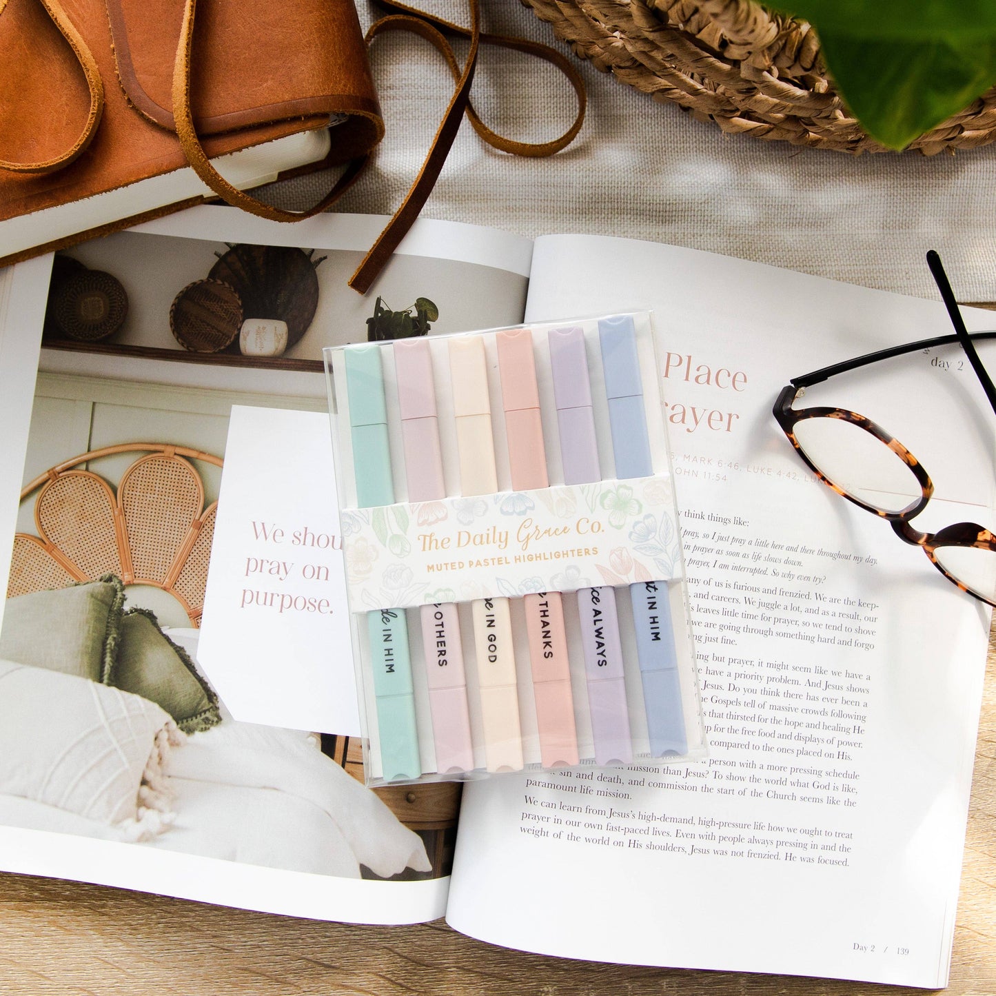 Pack of colorful cards on an open magazine with a pair of glasses and a basket in the background.