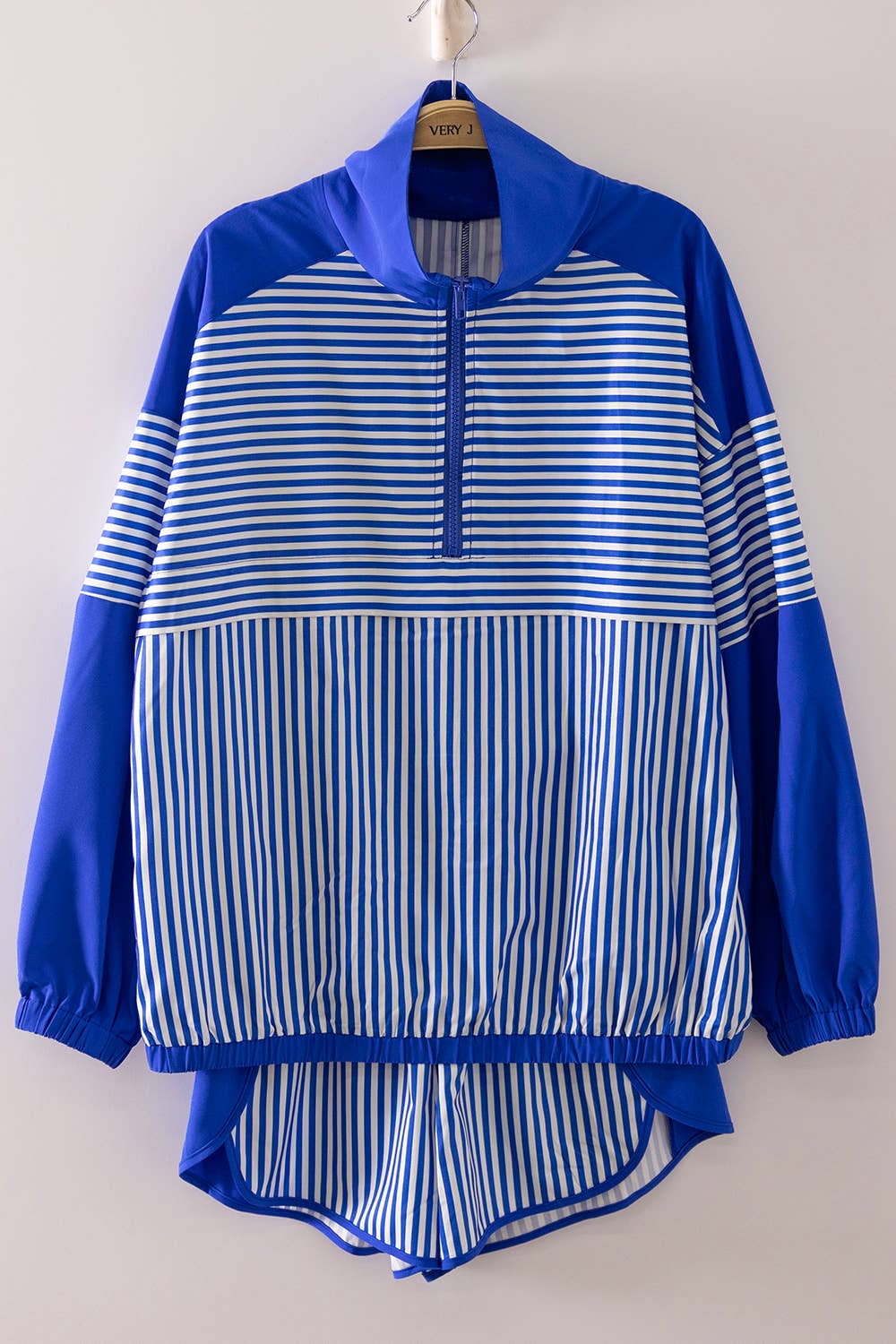 Blue and white striped jacket on a hanger against a plain background