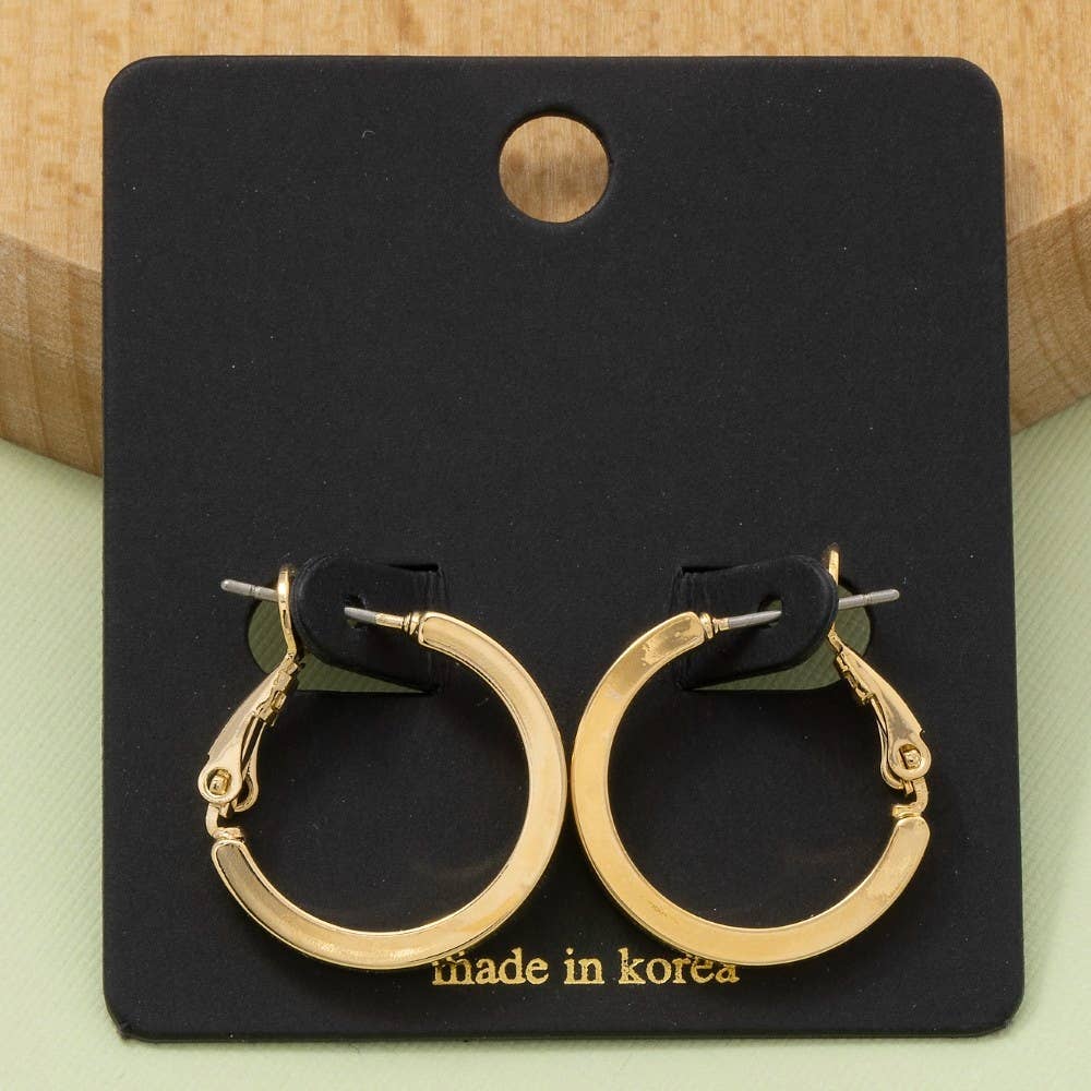 Gold hoop earrings on a black card labeled 'made in Korea' against a light green background.