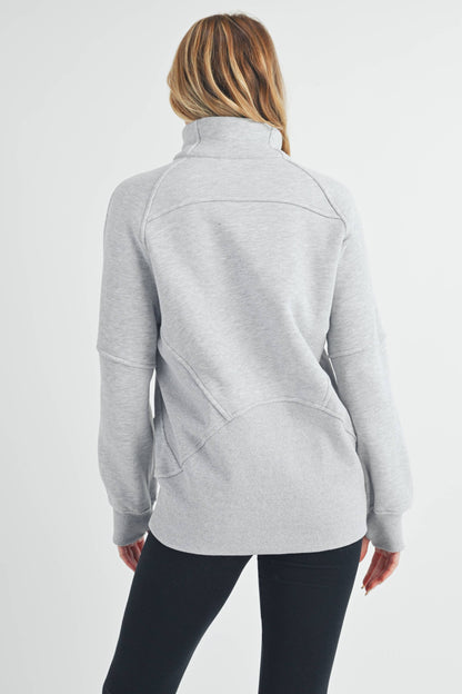 Person wearing a gray fleece jacket on a white background