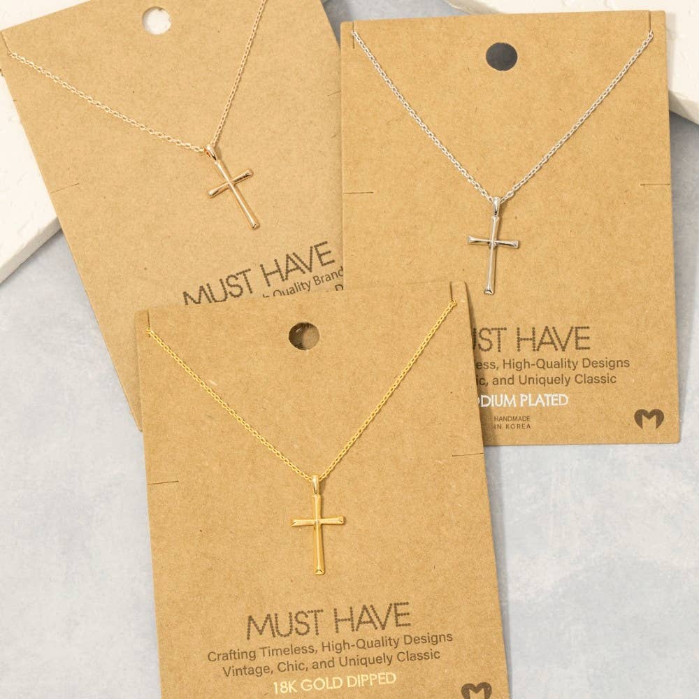 Gold cross necklaces on 'Must Have' branded cards with gold plating details.