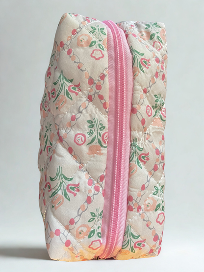 Floral-patterned pouch with a pink zipper on a light gray background