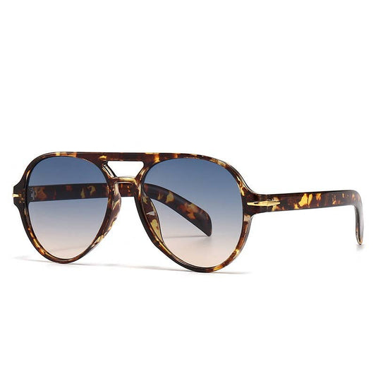 Tortoiseshell sunglasses with gradient lenses on a white background