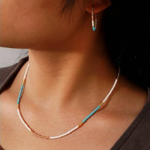 Necklace with colorful beads worn by a person.