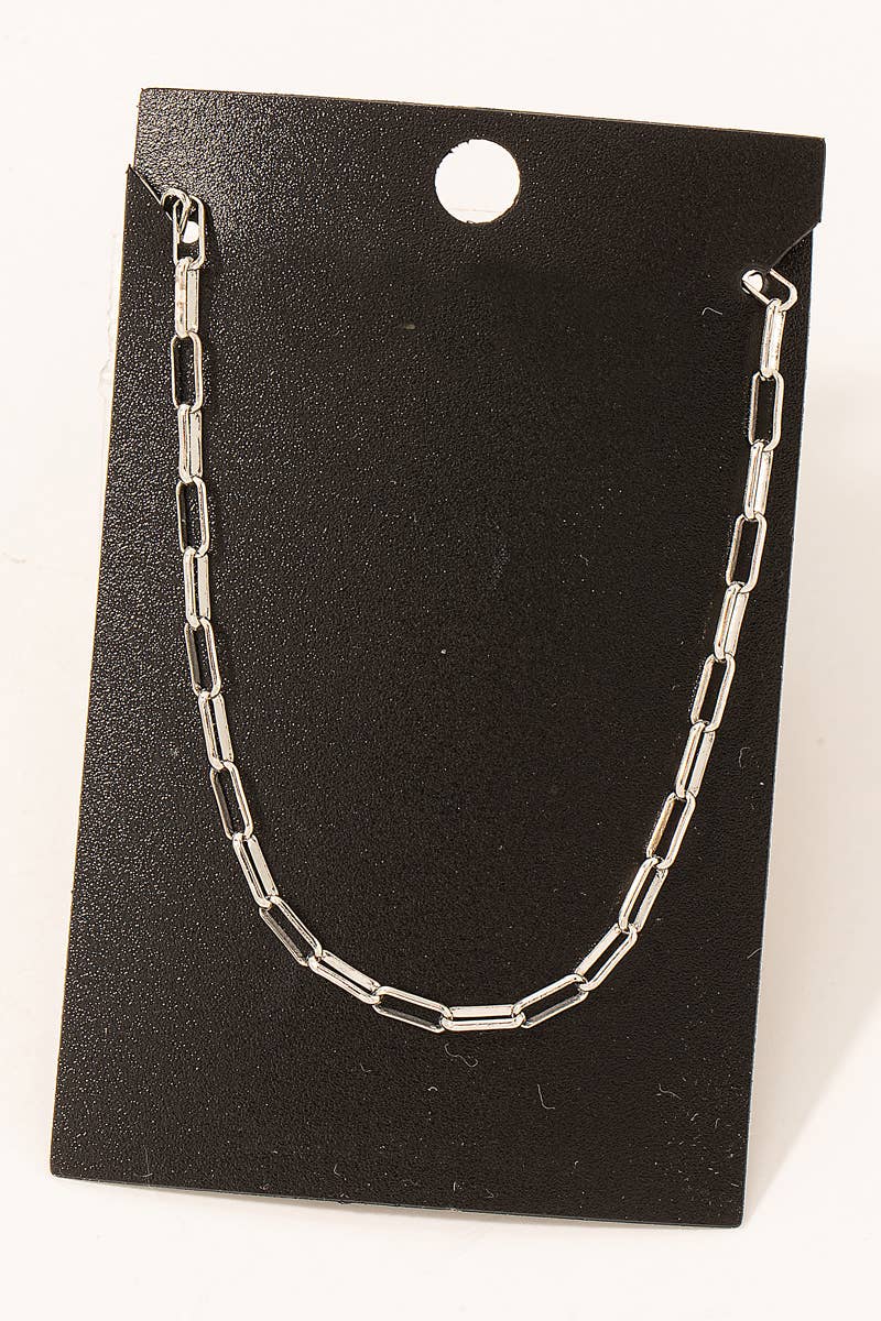 Silver chain necklace on a black card