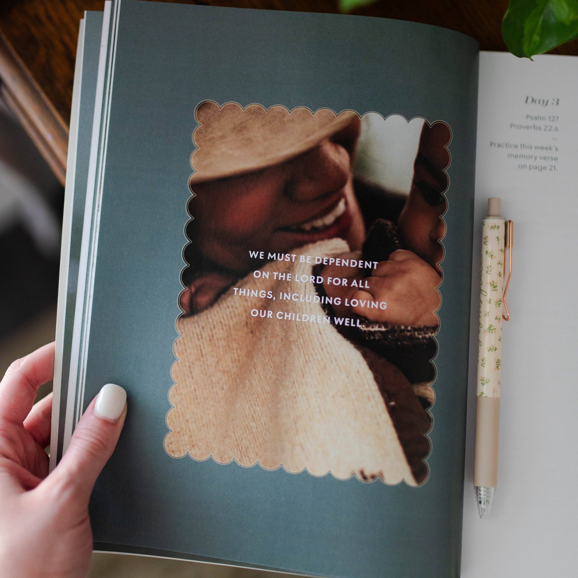 Book open to a page with a child in a sweater and hat, holding a teddy bear, with text underneath.