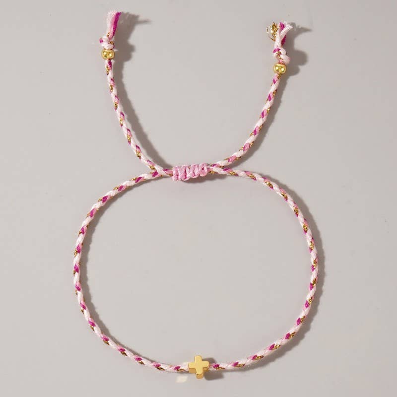Pink and gold braided bracelet on a gray background