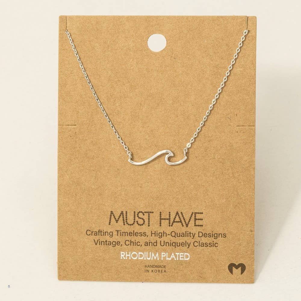 Silver necklace on a brown card with text about jewelry quality and design.
