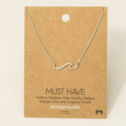 Silver necklace on a brown card with text about jewelry quality and design.