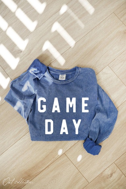 folded mineral washed blue sweatshirt with the words "GAME DAY"