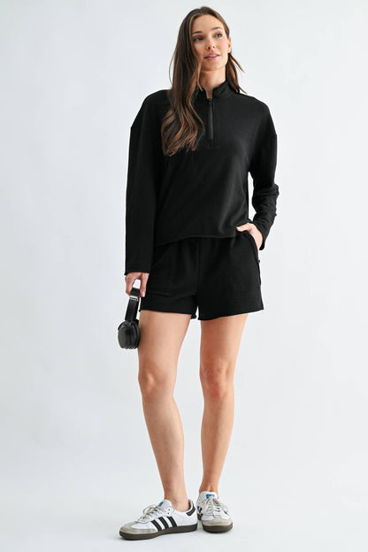 Woman wearing a black outfit with a white background