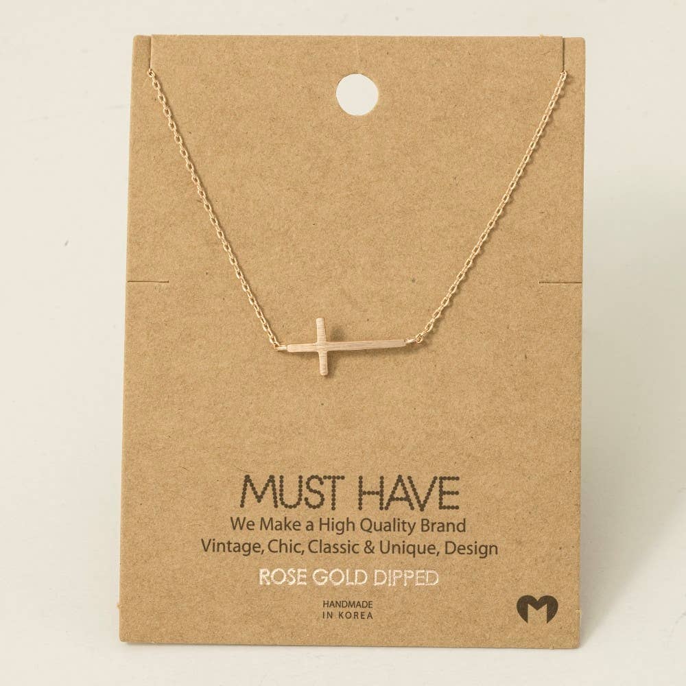 Rose gold dipped necklace on a brown card with text