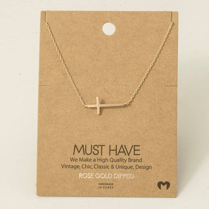 Rose gold dipped necklace on a brown card with text