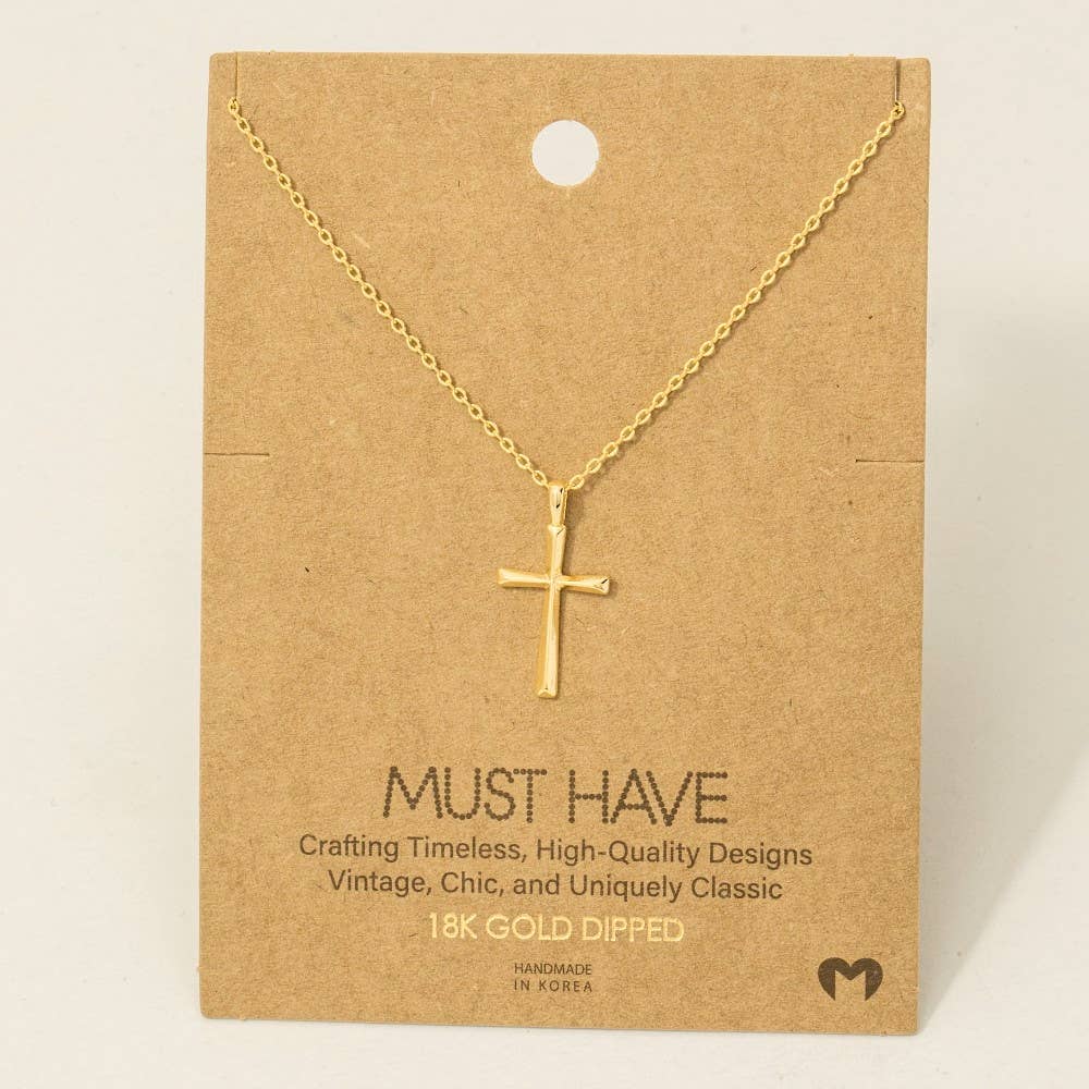 Gold cross necklace on a brown card with text
