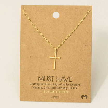 Gold cross necklace on a brown card with text