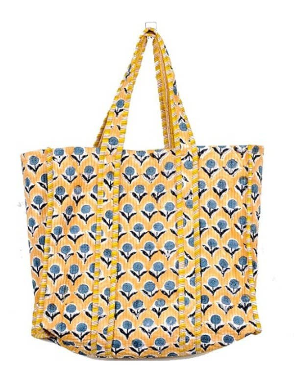 Yellow tote bag with blue floral pattern on a white background